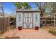 Well-maintained garden shed with decorative accents and a tidy, landscaped surrounding area at 7148 S Dahlia Ct, Centennial, CO 80122