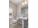 Half bathroom featuring a pedestal sink, tiled floor, and a window for natural light at 10154 Belvedere Loop, Lone Tree, CO 80124