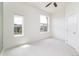 Bright bedroom with carpet flooring, two large windows with neighborhood views, and a ceiling fan at 10154 Belvedere Loop, Lone Tree, CO 80124