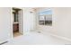 Spacious bedroom with carpet flooring, a large window view of neighborhood, and bathroom access at 10154 Belvedere Loop, Lone Tree, CO 80124