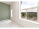 Bright bedroom with large windows showcasing neighborhood views and white walls with a pop of color at 10154 Belvedere Loop, Lone Tree, CO 80124