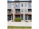 Modern townhome exterior with private outdoor spaces and green grass at 10154 Belvedere Loop, Lone Tree, CO 80124