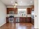 Open kitchen with stainless steel appliances, dark wood cabinets, and hardwood floors at 10154 Belvedere Loop, Lone Tree, CO 80124