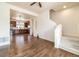 Open-concept living room with hardwood floors, staircase, and stainless kitchen at 10154 Belvedere Loop, Lone Tree, CO 80124