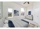 Serene main bedroom featuring stylish decor, neutral tones, and ample natural light from two windows at 10154 Belvedere Loop, Lone Tree, CO 80124