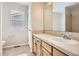 The bathroom has a well-lit mirror, a tile countertop, and wood cabinetry at 3523 Brushwood Dr, Castle Rock, CO 80109