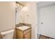 Bathroom featuring a single vanity, tile countertop, framed mirror and light fixture at 3523 Brushwood Dr, Castle Rock, CO 80109