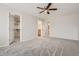 Bedroom featuring a ceiling fan, carpet, walk-in closet, and ensuite bathroom at 3523 Brushwood Dr, Castle Rock, CO 80109
