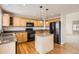 Bright kitchen with wooden cabinets, center island, and hardwood floors at 3523 Brushwood Dr, Castle Rock, CO 80109