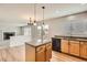 Kitchen featuring a center island, granite counters, and wood flooring at 3523 Brushwood Dr, Castle Rock, CO 80109