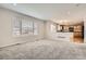 Open-concept living room with carpet flooring, window and connecting to kitchen area at 3523 Brushwood Dr, Castle Rock, CO 80109