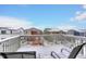 Snow covered deck overlooking community; two chairs, and string lights at 1944 Villageview Ln, Castle Rock, CO 80104