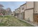 Spacious backyard with green grass and a partial view of home's exterior and fenced patio at 14344 E Hawaii Cir # B, Aurora, CO 80012