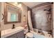 Updated bathroom features a shower and tub combination, a modern vanity, and updated tiling at 14344 E Hawaii Cir # B, Aurora, CO 80012