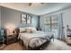 This bedroom features light blue walls, a ceiling fan, carpet and lots of natural light from the window at 14344 E Hawaii Cir # B, Aurora, CO 80012