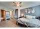This bedroom includes carpeted flooring, access to an ensuite bathroom, closet, and a queen-sized bed at 14344 E Hawaii Cir # B, Aurora, CO 80012