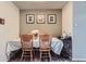 Cozy dining room features wood table with seating for four and decorative wall art at 14344 E Hawaii Cir # B, Aurora, CO 80012