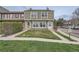 Well-kept townhome exterior with a grassy lawn and nearby street parking at 14344 E Hawaii Cir # B, Aurora, CO 80012