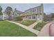 Well-maintained townhome exterior with manicured lawn and a 