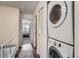 Upstairs hallway with stacked washer and dryer laundry setup near the bedrooms at 14344 E Hawaii Cir # B, Aurora, CO 80012