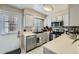 Functional kitchen featuring white cabinets, tile floors, stainless steel appliances, and a contrasting black sink at 14344 E Hawaii Cir # B, Aurora, CO 80012