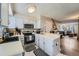 Efficient kitchen with white cabinets, modern appliances, and black and white floor mat at 14344 E Hawaii Cir # B, Aurora, CO 80012