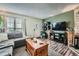 Cozy living room features wood-look floors, comfortable sofa and a flatscreen tv with decorative shelving at 14344 E Hawaii Cir # B, Aurora, CO 80012
