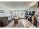 This living room includes a large sofa, hard surface floors, and a flat screen television at 14344 E Hawaii Cir # B, Aurora, CO 80012