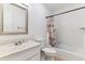 Bathroom featuring a shower-tub combo with white tile and a single sink vanity at 625 S Xenon Ct, Lakewood, CO 80228