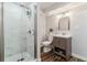 Modern bathroom featuring a glass enclosed shower, a gray vanity, and wood-look flooring at 625 S Xenon Ct, Lakewood, CO 80228