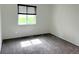 Bright bedroom with window overlooking the yard and neutral carpet at 625 S Xenon Ct, Lakewood, CO 80228