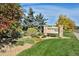 A lushly landscaped Addenbrooke Park sign featuring colorful greenery and a clear blue sky at 625 S Xenon Ct, Lakewood, CO 80228
