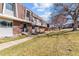 Brick townhome exterior with manicured lawn and sidewalk leading to front door at 625 S Xenon Ct, Lakewood, CO 80228