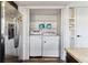 Convenient laundry area next to the stainless steel refrigerator with a washer and dryer inside a closet at 625 S Xenon Ct, Lakewood, CO 80228