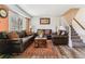 Cozy living room with hardwood floors, plush furniture, and natural light at 625 S Xenon Ct, Lakewood, CO 80228