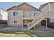 Two-story home with deck with stairs to the yard and backyard featuring low maintenance landscaping at 24437 E Powers Ave, Aurora, CO 80016