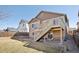 Two-story home with a cozy backyard featuring a deck with stairs and low maintenance landscaping at 24437 E Powers Ave, Aurora, CO 80016