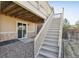 Stairs descending from the deck to the yard and a sliding door access to the home at 24437 E Powers Ave, Aurora, CO 80016