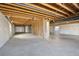 Unfinished basement space featuring exposed ceiling with beams at 24437 E Powers Ave, Aurora, CO 80016