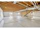 Unfinished basement with exposed ceiling, rough-in plumbing, and natural light at 24437 E Powers Ave, Aurora, CO 80016