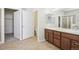 Bathroom featuring double sink vanity, a walk-in closet and a separate water closet at 24437 E Powers Ave, Aurora, CO 80016