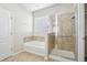 Bathroom featuring a tub with tiled surround and glass door shower at 24437 E Powers Ave, Aurora, CO 80016