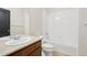 Bathroom features a tub with a tiled shower and a vanity with a sink and neutral countertops at 24437 E Powers Ave, Aurora, CO 80016