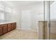 Bathroom featuring double sink vanity, glass enclosed shower, and tile flooring at 24437 E Powers Ave, Aurora, CO 80016