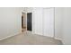 Bedroom featuring neutral colored walls, carpeted floors, and a closet with sliding doors at 24437 E Powers Ave, Aurora, CO 80016