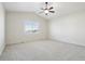 Spacious bedroom with large window, neutral walls and carpet with a ceiling fan at 24437 E Powers Ave, Aurora, CO 80016