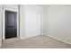 Neutral bedroom with carpeted floors, large closet, and modern colored door at 24437 E Powers Ave, Aurora, CO 80016