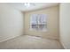 This bedroom features a large window offering ample natural light and a view of the outdoors at 24437 E Powers Ave, Aurora, CO 80016