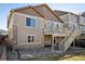Back of home featuring two-story design with a deck, stairs, and low-maintenance landscaping at 24437 E Powers Ave, Aurora, CO 80016