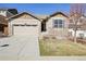 Charming home featuring a two-car garage, stone accents, and a well-maintained lawn at 24437 E Powers Ave, Aurora, CO 80016